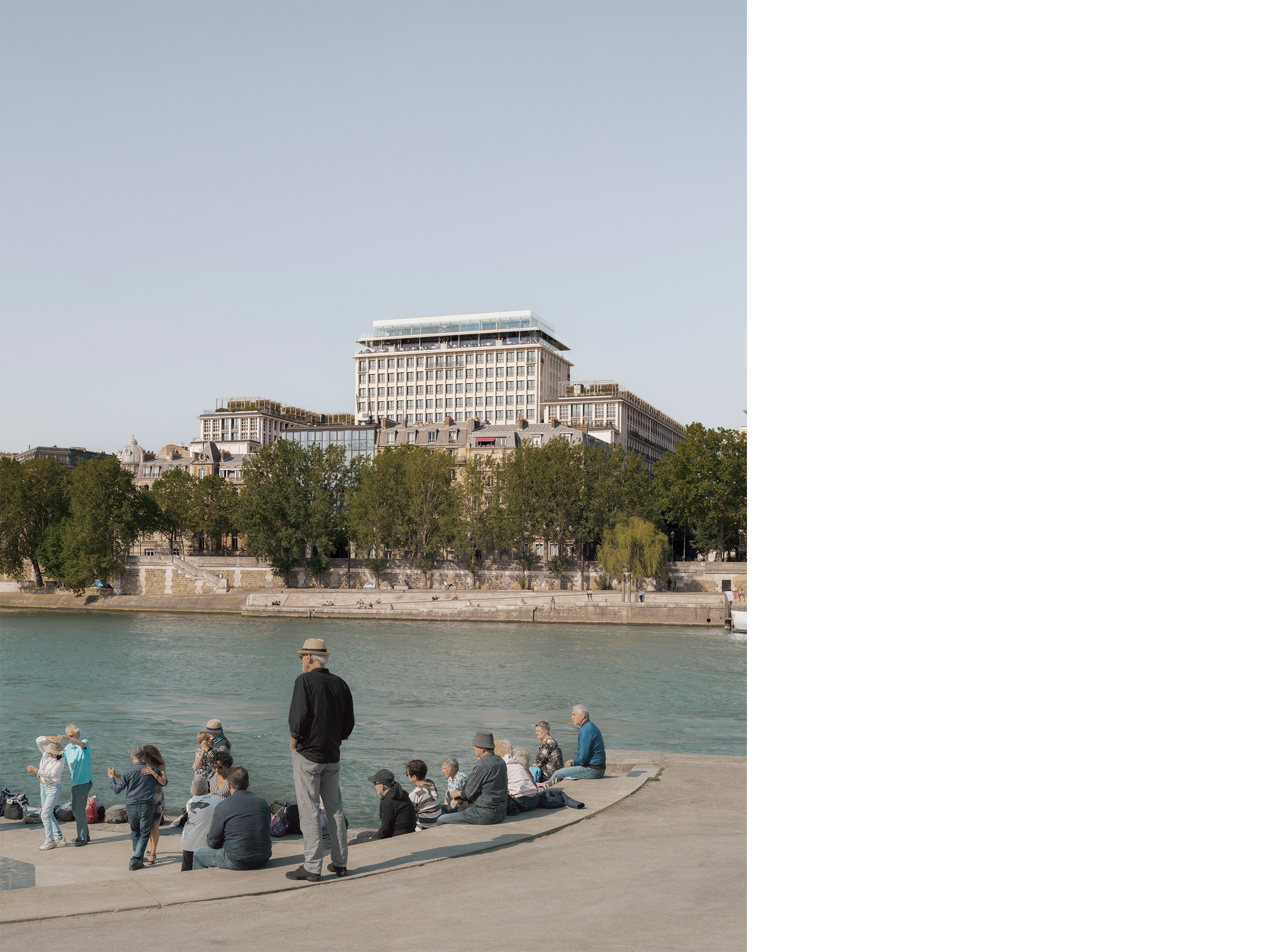 People gathering along the banks of the Seine with Morland Mixité Capitale in the background, illustrating the project’s relationship to the river and public life in central Paris.