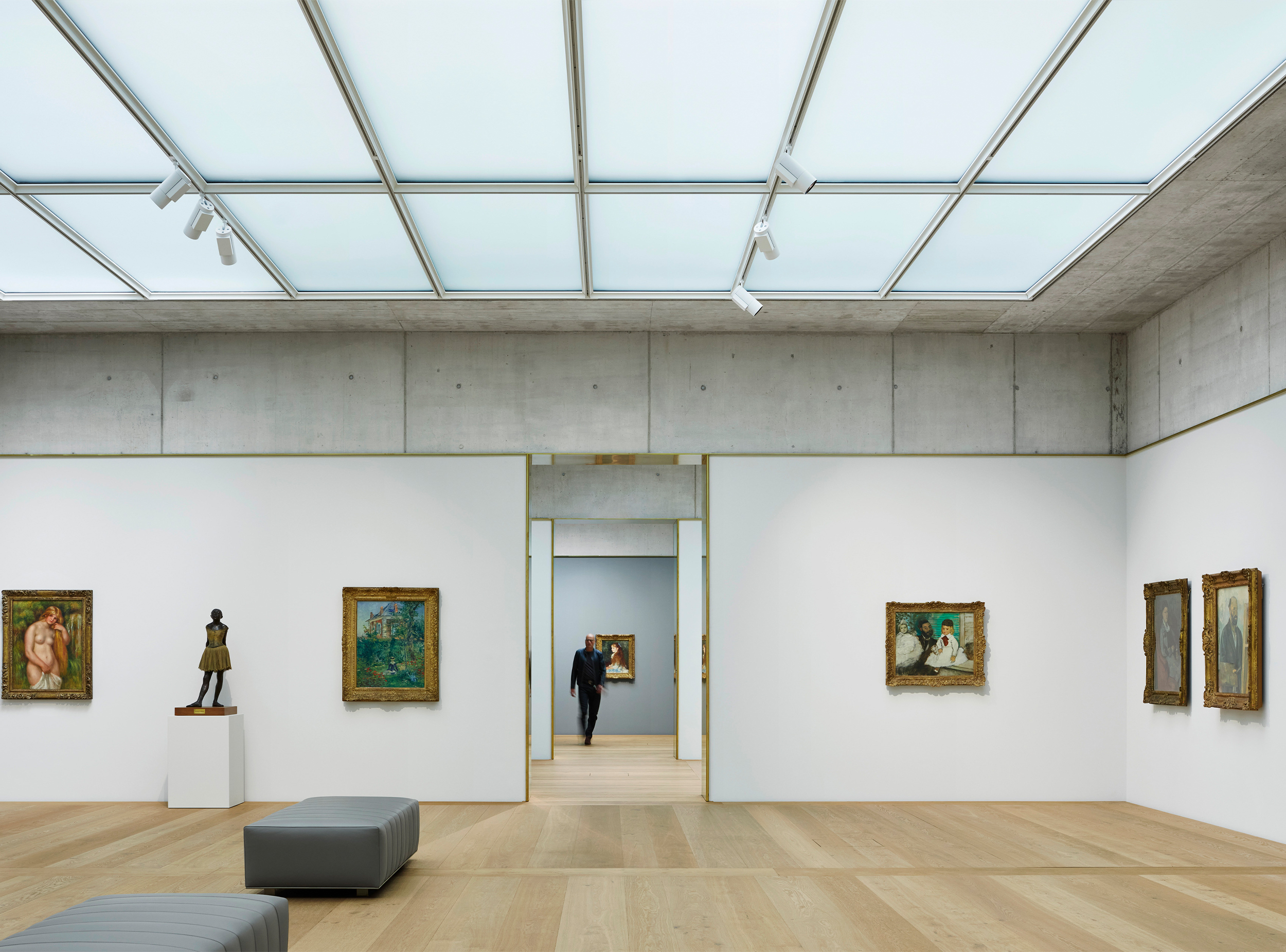 A temporary exhibition gallery in the Kunsthaus Zürich Extension is lit by a continuous diffuse daylight ceiling, combining natural light, exposed concrete and carefully proportioned rooms to create an adaptable environment for viewing art.