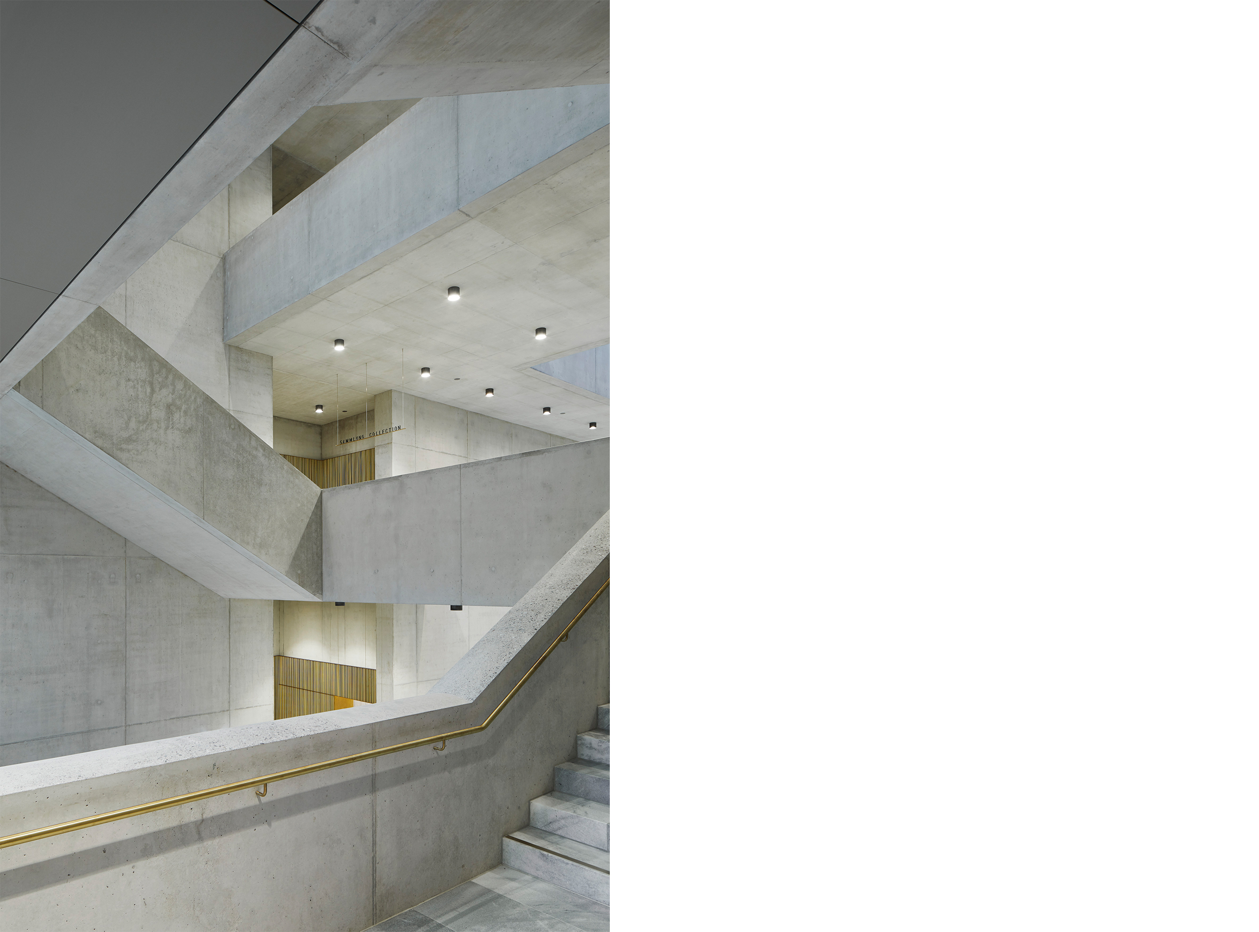 The central stair hall of the Kunsthaus Zürich Extension is formed by a sequence of intersecting concrete stairways and landings, creating a spatial composition that guides movement through the museum while expressing the clarity of its structural and architectural organisation.