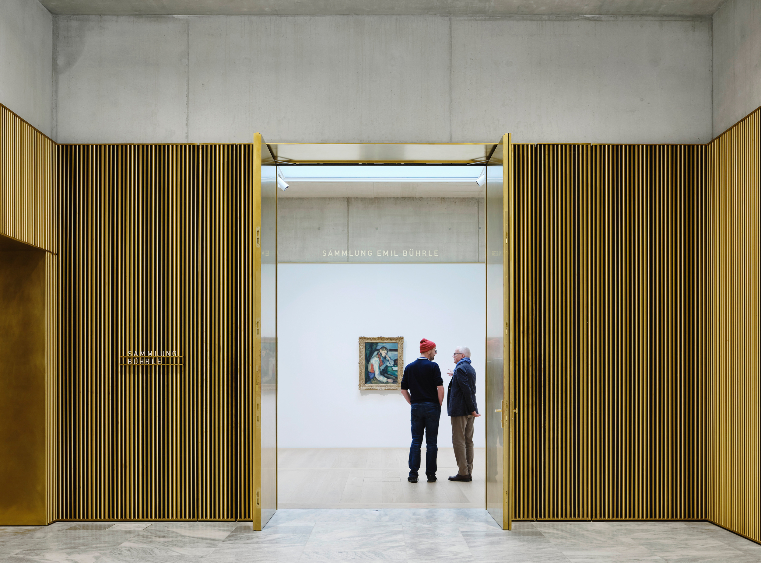 Brass-framed gallery entrance in the Kunsthaus Zürich Extension, marking the transition from the public hall to the exhibition spaces.