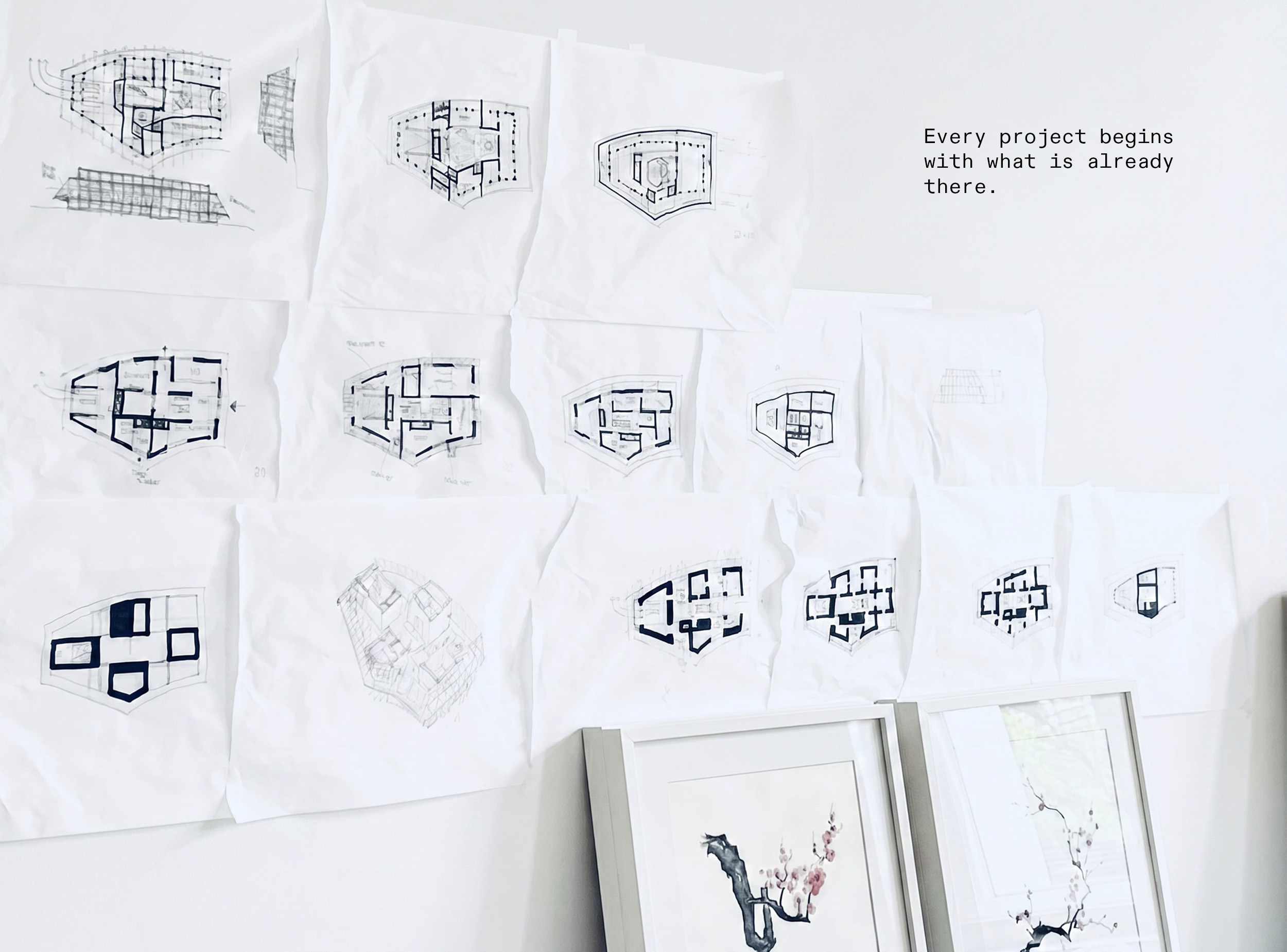 hand drawn sketches of floor plans on a wall with a quote: Every project begins with what is already there. 